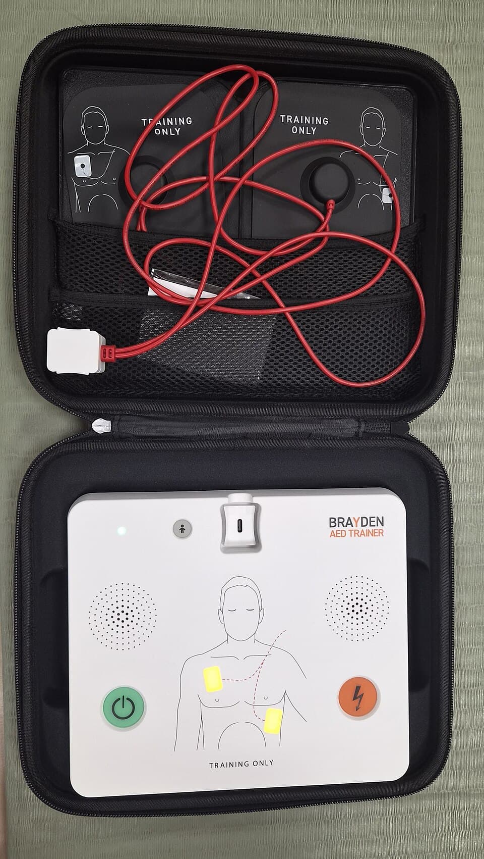 AED Trainer in protective case with training pads