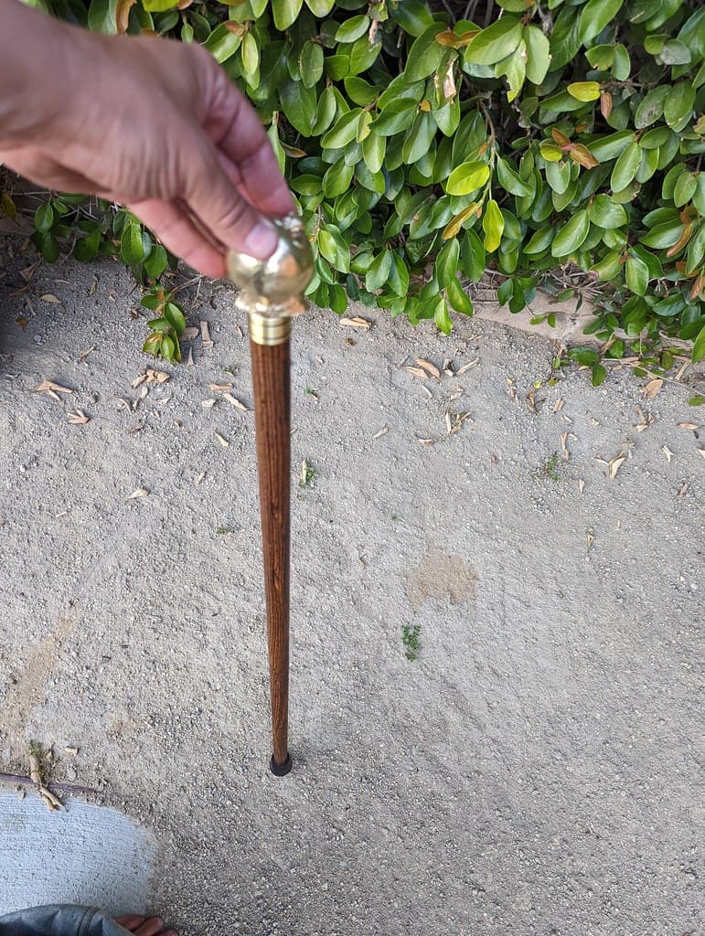 Brass casting of my excised arthritic femoral head and hip joint, with machined screw, affixed to custom cane.